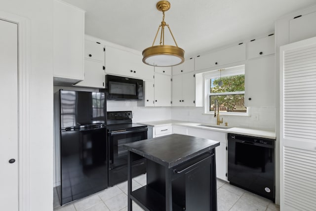 kitchen with black appliances, a sink, tasteful backsplash, white cabinetry, and light tile patterned floors