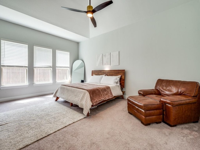 carpeted bedroom with ceiling fan and baseboards