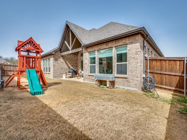 view of play area with a yard and fence