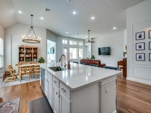 kitchen featuring light wood-style floors, light countertops, a sink, and stainless steel dishwasher