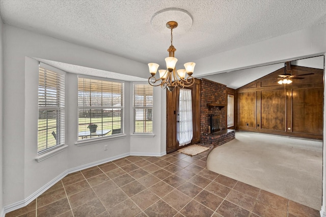 unfurnished living room featuring vaulted ceiling, dark colored carpet, a textured ceiling, and a fireplace