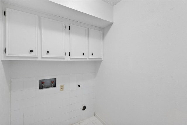 laundry area with cabinet space, hookup for a washing machine, and electric dryer hookup