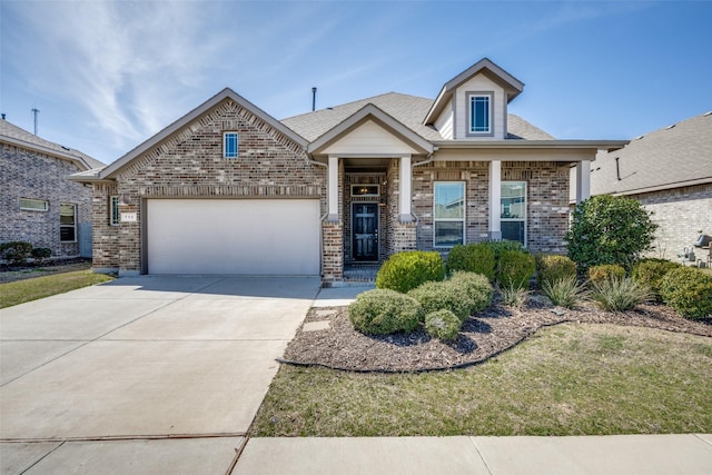 view of front of property with a garage, concrete driveway, and brick siding