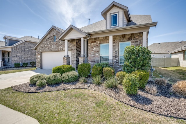 view of front facade featuring concrete driveway, a front lawn, an attached garage, brick siding, and fence