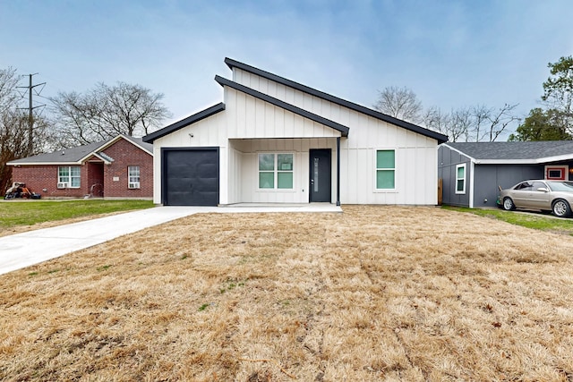 modern farmhouse with board and batten siding, a front yard, concrete driveway, and a garage