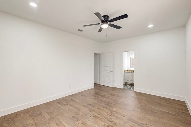 spare room featuring recessed lighting, ceiling fan, light wood-style flooring, and baseboards