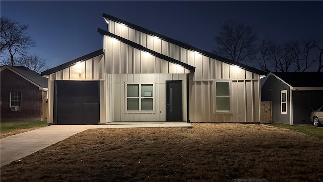 view of front of house featuring a garage, board and batten siding, and concrete driveway