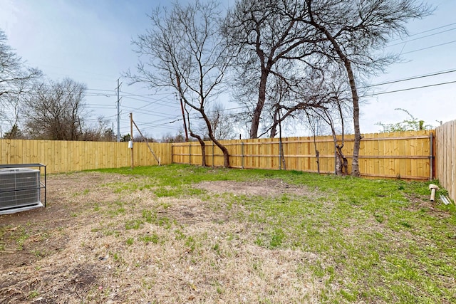 view of yard with cooling unit and a fenced backyard