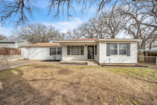 back of property with fence and a lawn