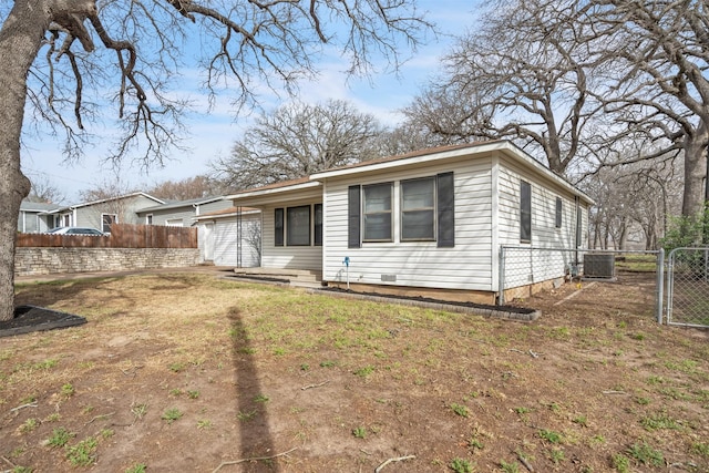 view of front of property featuring central air condition unit, a gate, and fence