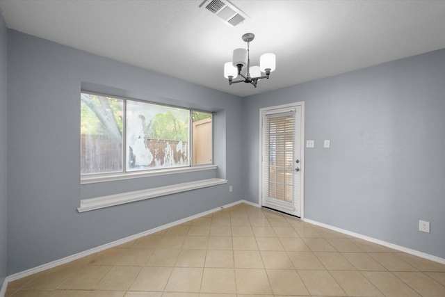 interior space with baseboards, light tile patterned floors, visible vents, and a notable chandelier