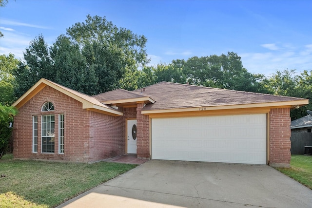 ranch-style house featuring a garage, brick siding, and driveway