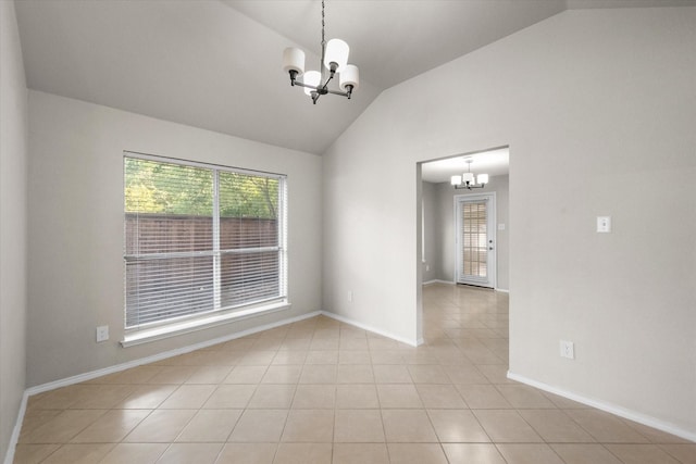 spare room featuring light tile patterned floors, vaulted ceiling, and a notable chandelier