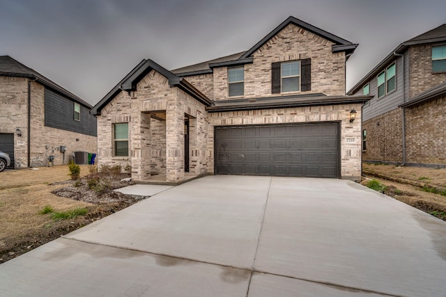 view of front of house featuring driveway, brick siding, and an attached garage