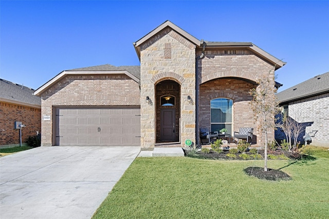 french provincial home with driveway, a front lawn, stone siding, covered porch, and an attached garage