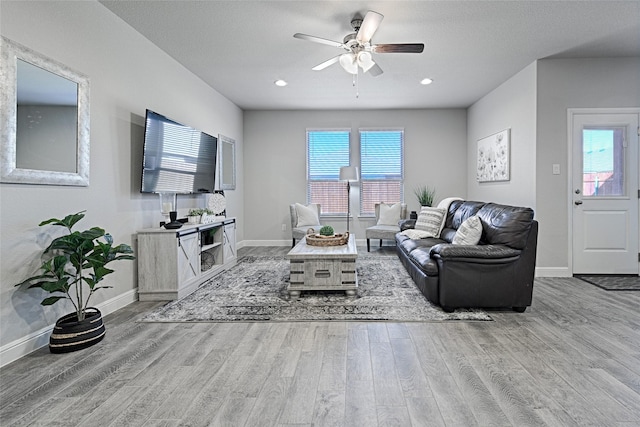 living area featuring recessed lighting, baseboards, a ceiling fan, and wood finished floors