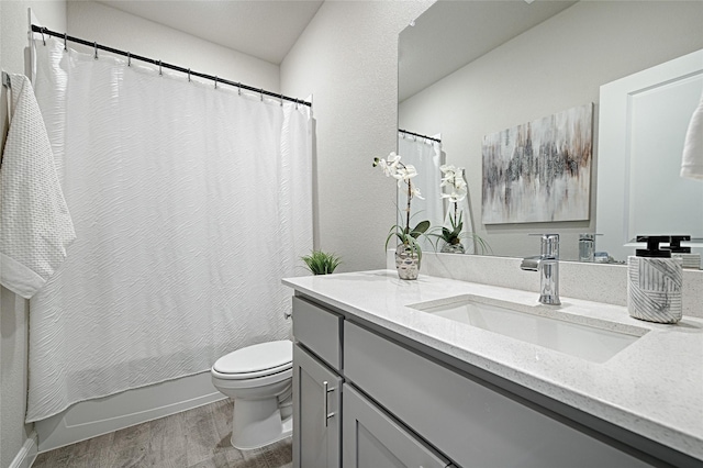 full bathroom featuring vanity, shower / bath combination with curtain, toilet, and wood finished floors