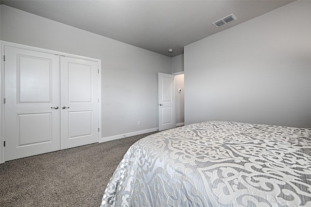 carpeted bedroom featuring a closet, visible vents, and baseboards