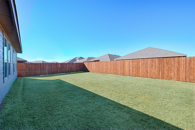 view of yard with a fenced backyard