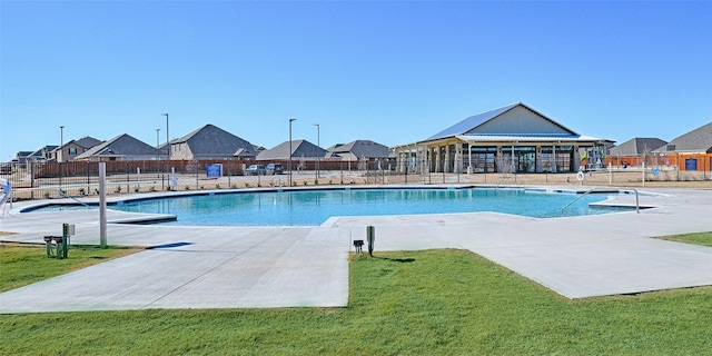 pool with a residential view and fence