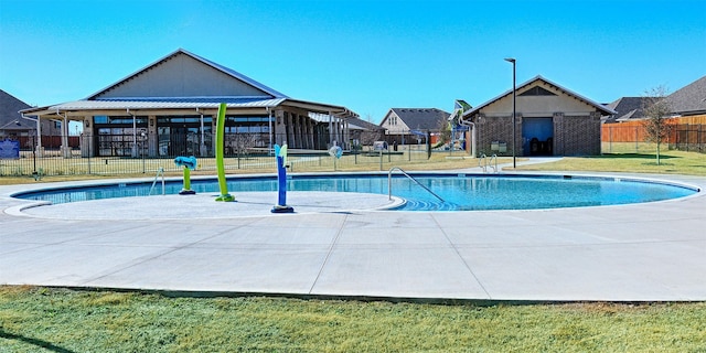 pool featuring a patio, a yard, and fence