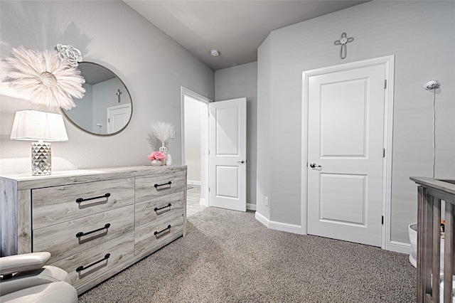 bedroom featuring light colored carpet and baseboards