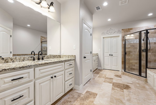 bathroom featuring recessed lighting, visible vents, a shower stall, and vanity