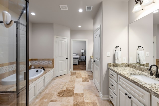 bathroom featuring recessed lighting, visible vents, a garden tub, and vanity