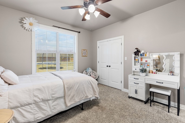 bedroom with light carpet, ceiling fan, and baseboards