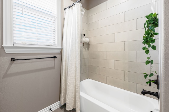 bathroom with shower / bath combo with shower curtain