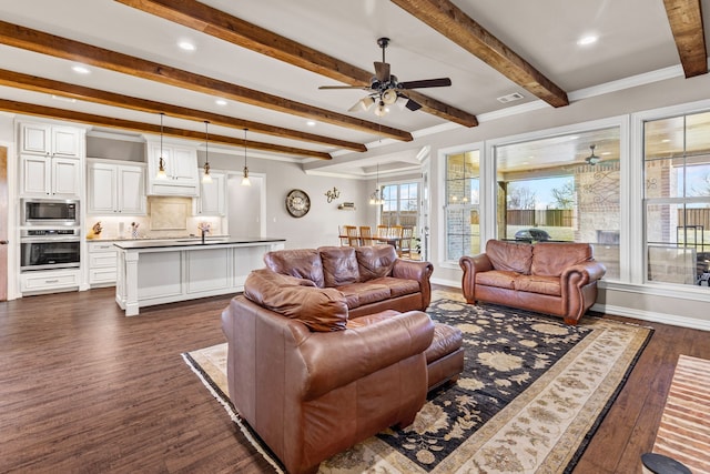 living room with ceiling fan, visible vents, baseboards, beam ceiling, and dark wood finished floors