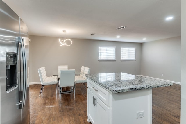 kitchen featuring dark wood-style floors, white cabinetry, visible vents, and stainless steel refrigerator with ice dispenser