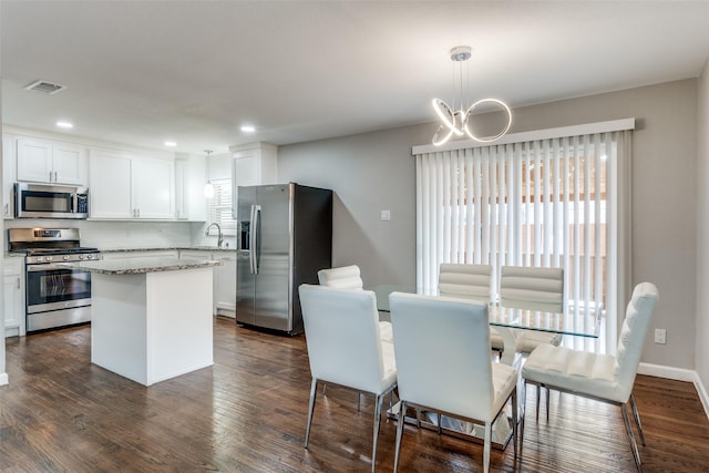 kitchen with stainless steel appliances, plenty of natural light, and white cabinets