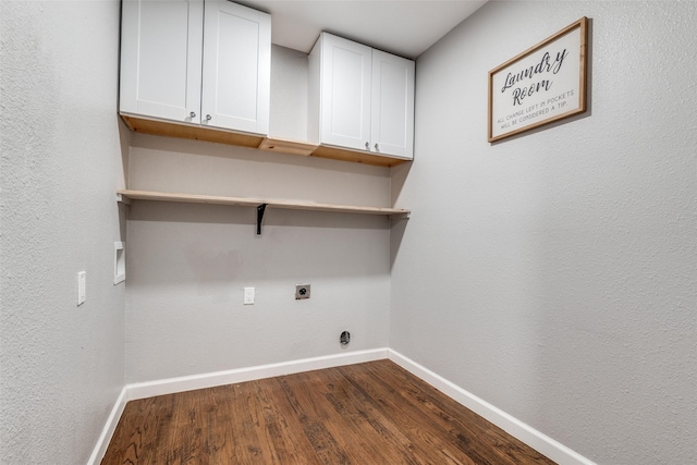 clothes washing area featuring baseboards, dark wood-style floors, cabinet space, and hookup for an electric dryer