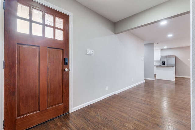 entrance foyer featuring baseboards, beamed ceiling, dark wood-style flooring, and recessed lighting