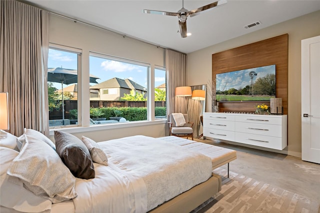 bedroom with visible vents, concrete floors, and a ceiling fan