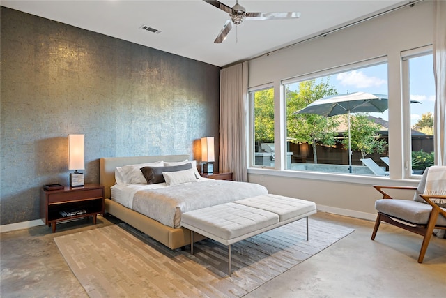 bedroom featuring a ceiling fan, baseboards, visible vents, and concrete flooring