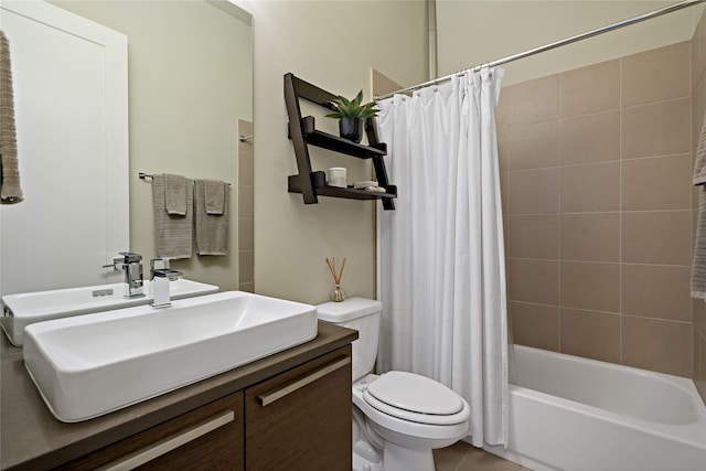 full bath with tile patterned floors, shower / bath combo with shower curtain, toilet, and vanity