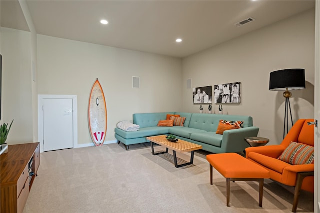 living area with recessed lighting, light colored carpet, baseboards, and visible vents