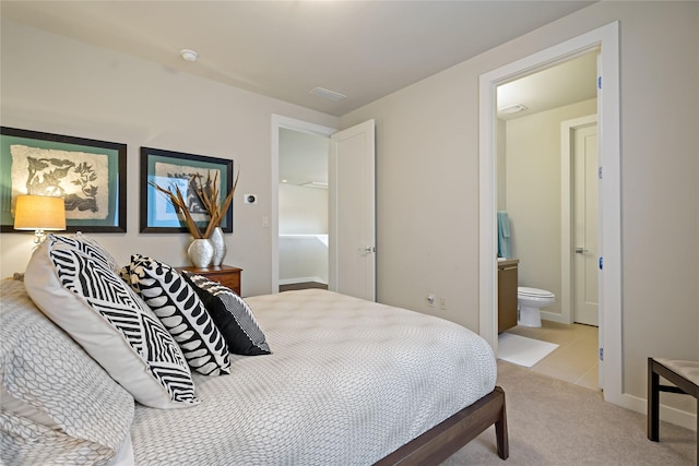 bedroom featuring visible vents, light colored carpet, ensuite bath, and baseboards