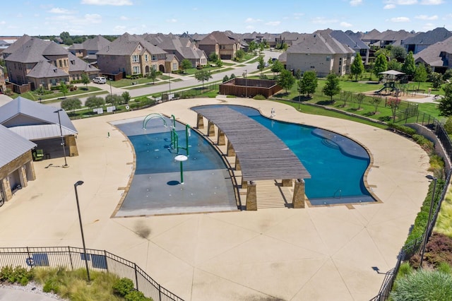 view of pool featuring a residential view and fence