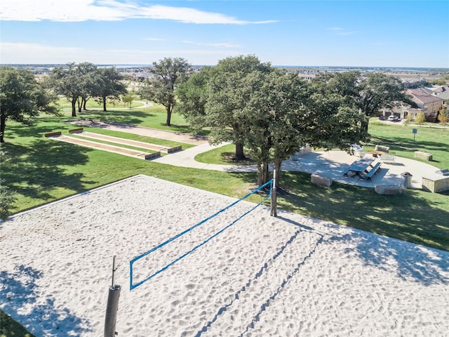 view of home's community with a lawn and volleyball court