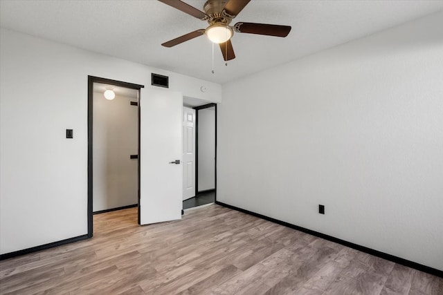 unfurnished bedroom with visible vents, baseboards, and light wood-style floors