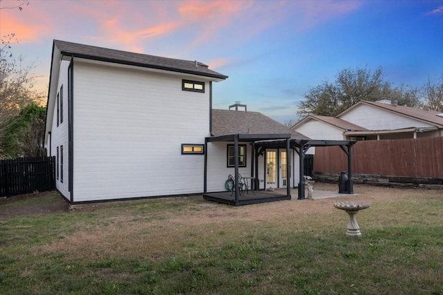 back of property with french doors, a yard, a fenced backyard, a patio area, and a pergola