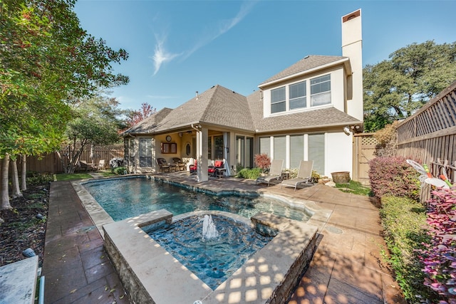 back of house with a chimney, roof with shingles, a patio area, and a fenced backyard