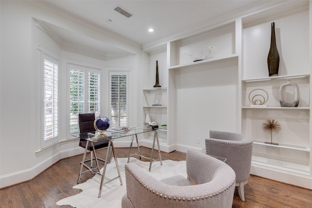 office featuring baseboards, visible vents, wood finished floors, built in shelves, and recessed lighting