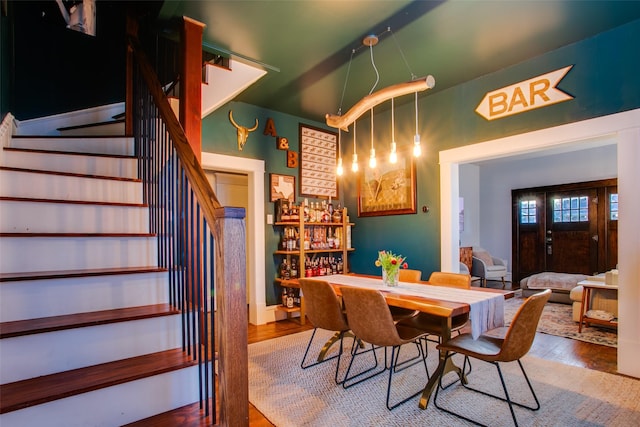 dining space featuring stairs and wood finished floors