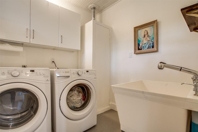 laundry area featuring washing machine and clothes dryer, cabinet space, and a sink