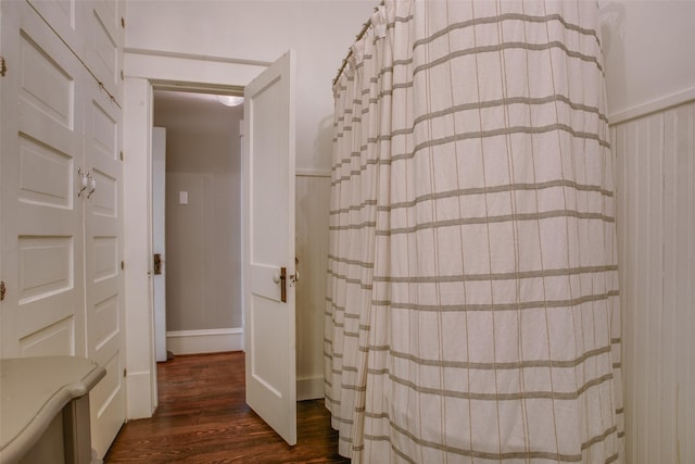 full bathroom featuring curtained shower and wood finished floors