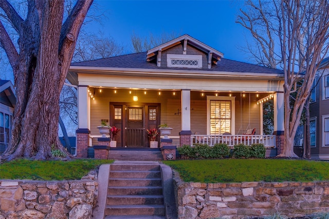 view of front facade featuring a porch and a shingled roof